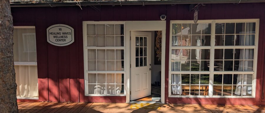 The welcoming entrance to Healing Waves Wellness Center, open door and deck