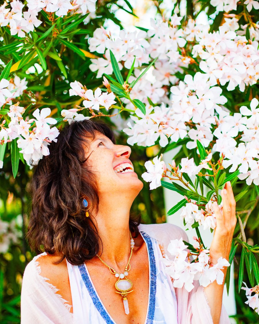 Dr. Melanie Hernand Shine laughing among blossoms